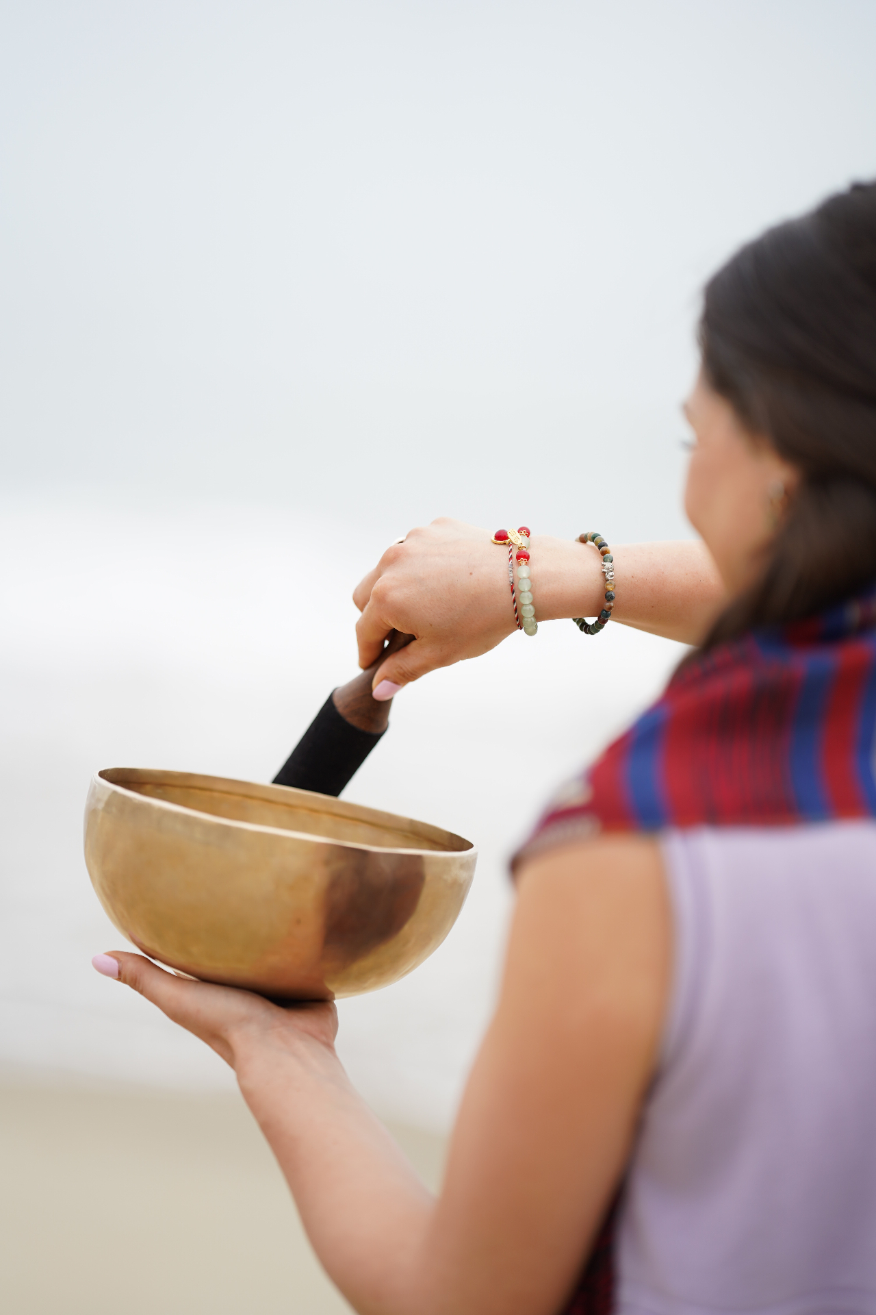 Madeleine, Reiki Master and meditation teacher, holding a Tibetan singing bowl